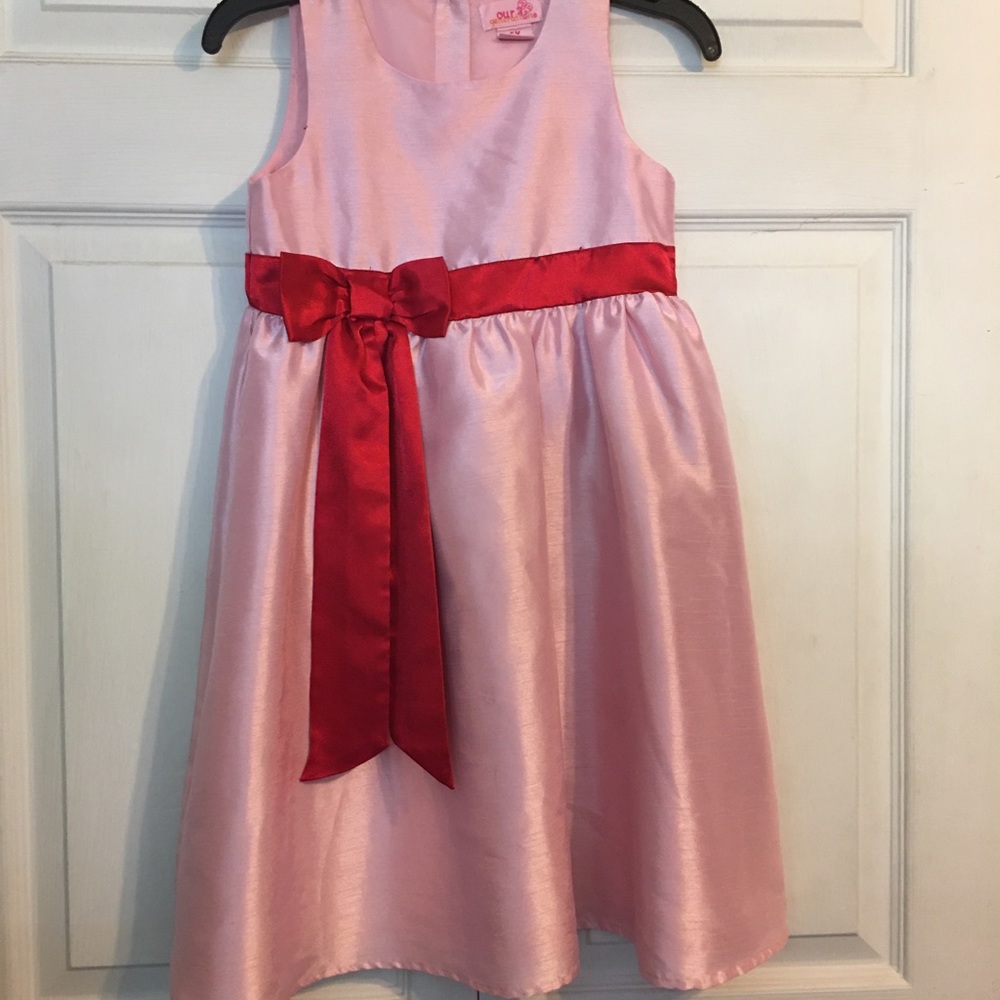 Pink dress with red ribbon on the front
